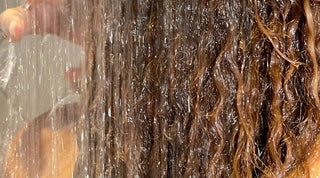 Curly haired girl using sulfate free shampoo and conditioner